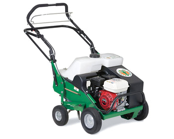 Green lawn aerator with four wheels, gas engine, and ergonomic handle for easy maneuvering.