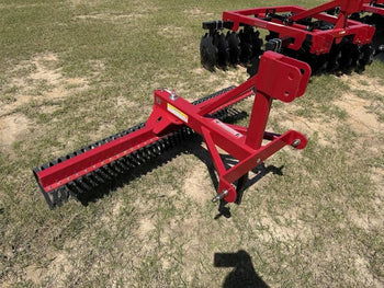 Red agricultural landscape rake, durable steel, ideal for leveling soil and removing debris.