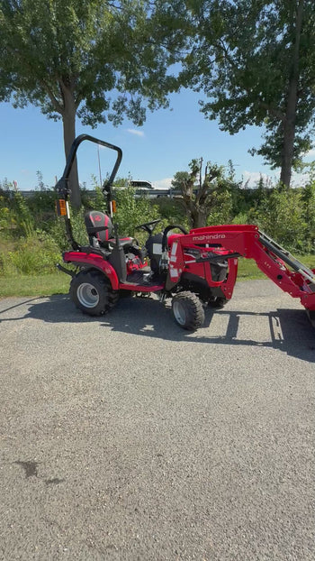 Mahindra compact tractor in red with loader, durable tires, perfect for landscaping and gardening tasks.